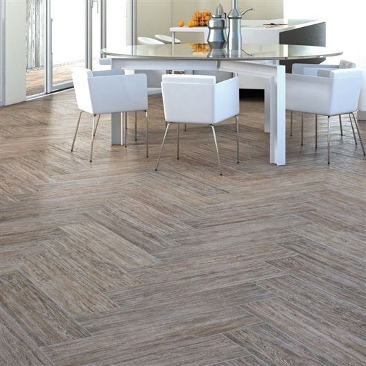 A dining room with a table and chairs and a wooden floor