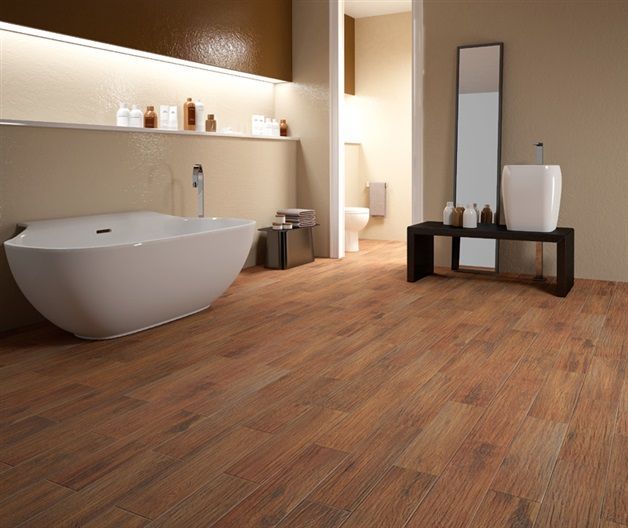 A bathroom with a bathtub , sink and mirror