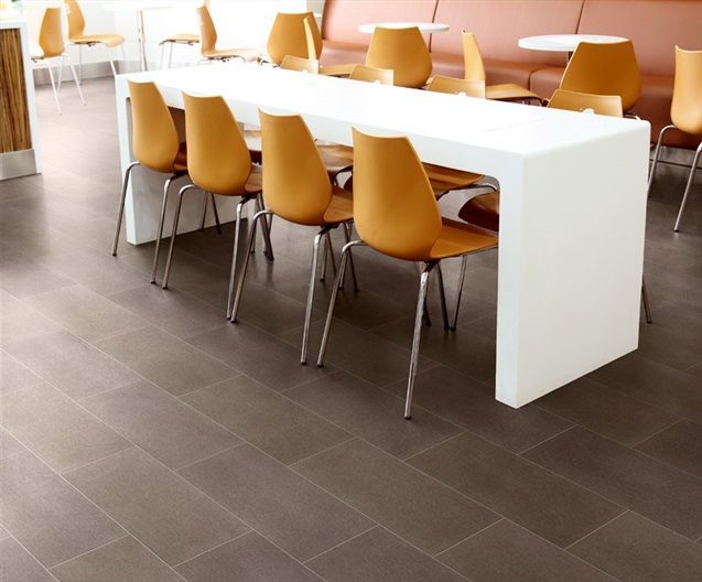 A dining room with a long table and chairs