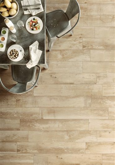 A table with plates of food on it and a wooden floor.