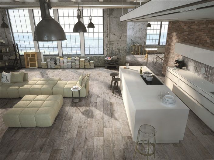 A living room with a couch and a kitchen