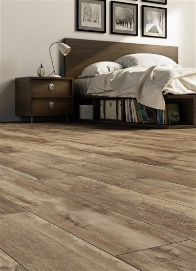 A bedroom with a wooden floor and a bed.