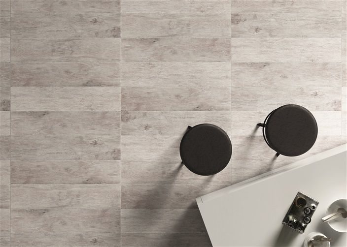 Two stools are sitting on a wooden floor next to a table.
