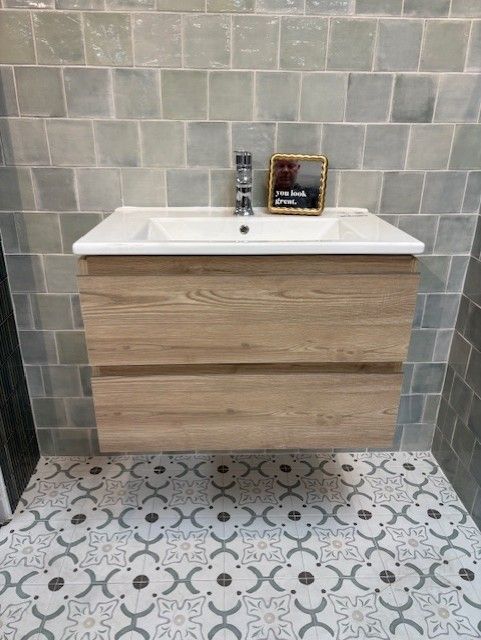 A bathroom with a sink and a mirror on the wall.
