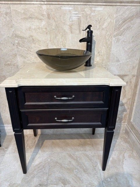 A bathroom vanity with a sink and a faucet