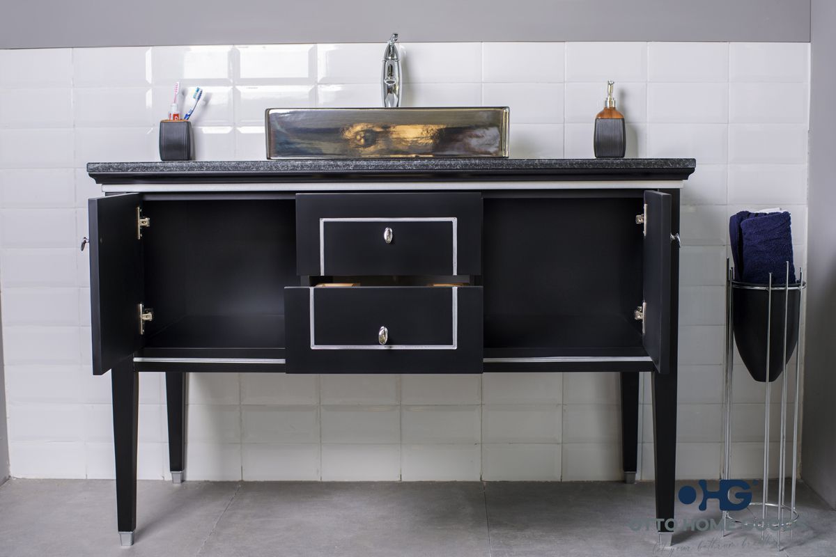 A bathroom with a black vanity and a sink
