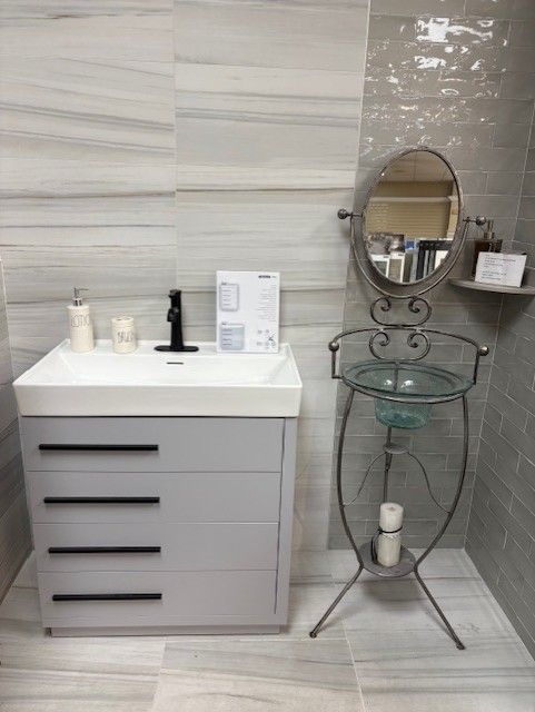 A bathroom with a sink , mirror and a glass sink.