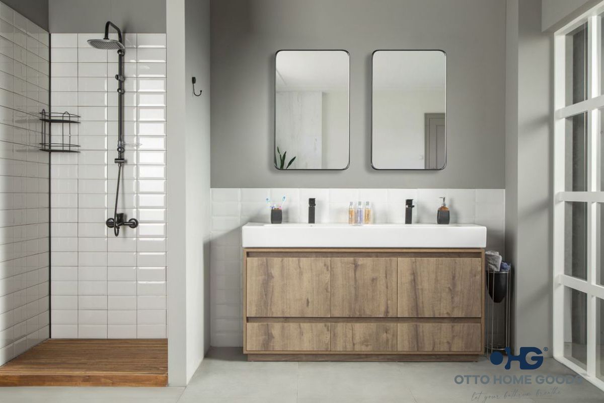 A bathroom with a sink , mirrors , and a walk in shower.