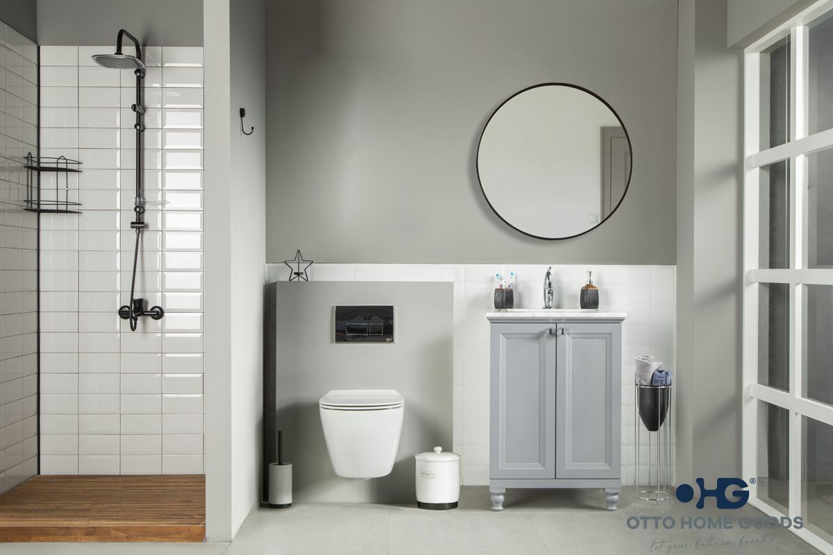A bathroom with a toilet , sink , mirror and shower.