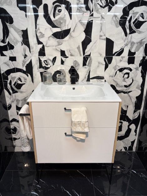 A bathroom with a sink and a towel hanging from it.