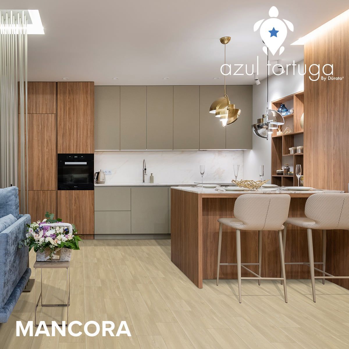 A living room with a blue couch and a kitchen with stools