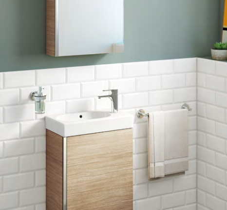 A bathroom with a sink , mirror and towel rack