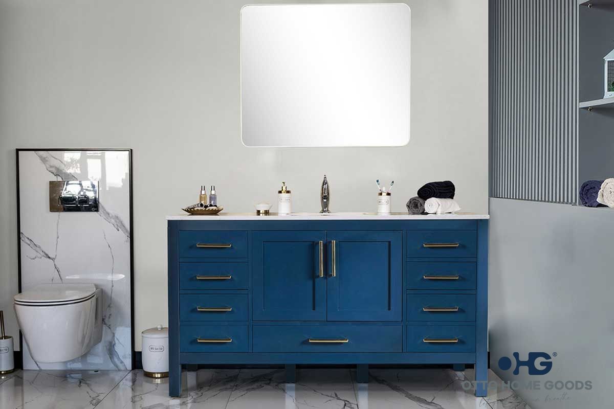 A bathroom with a blue vanity , sink , mirror and toilet.