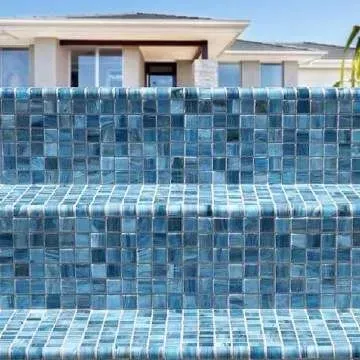 A close up of a staircase with blue tiles in front of a house.