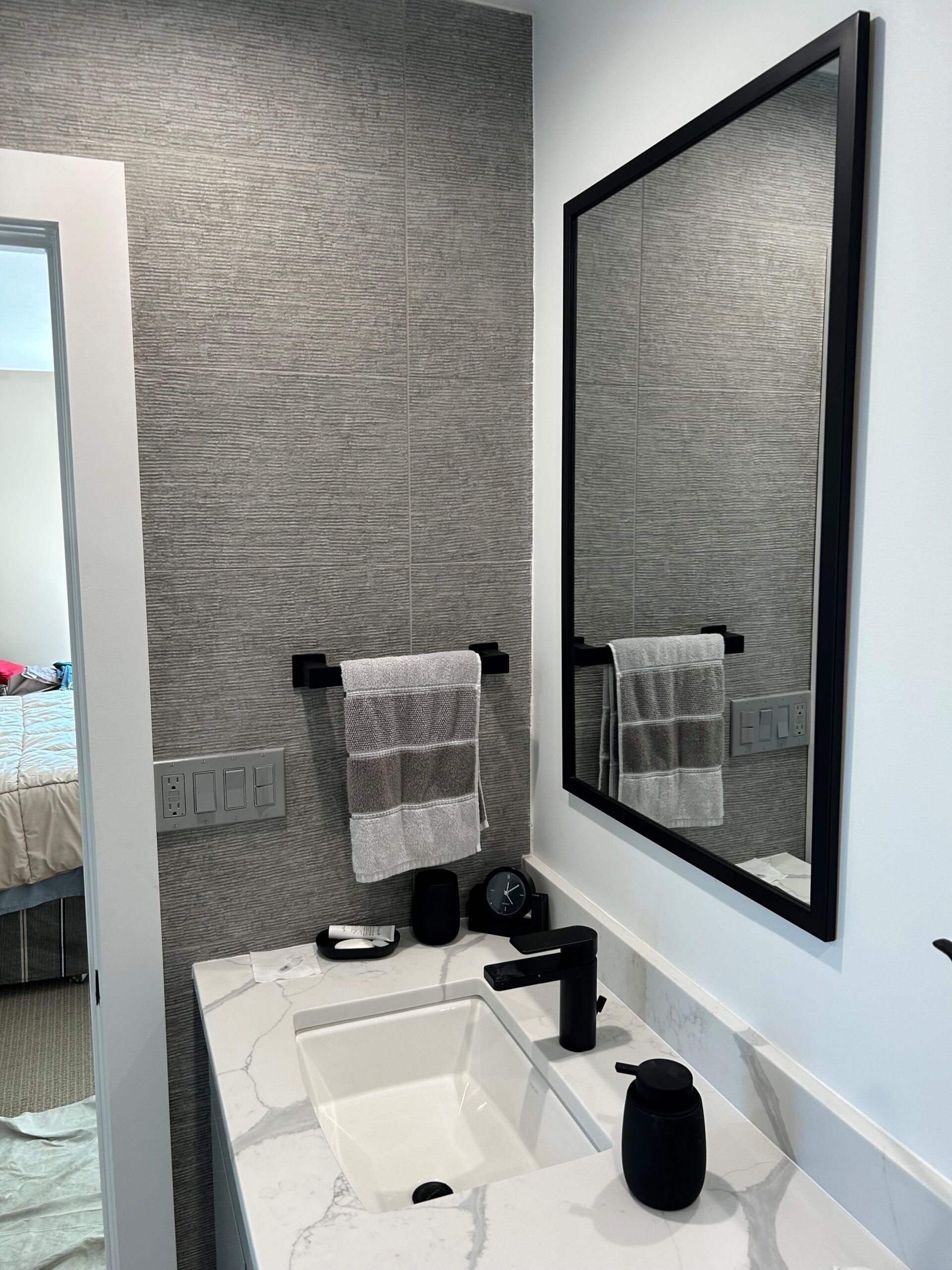 A bathroom with a sink and a mirror on the wall.