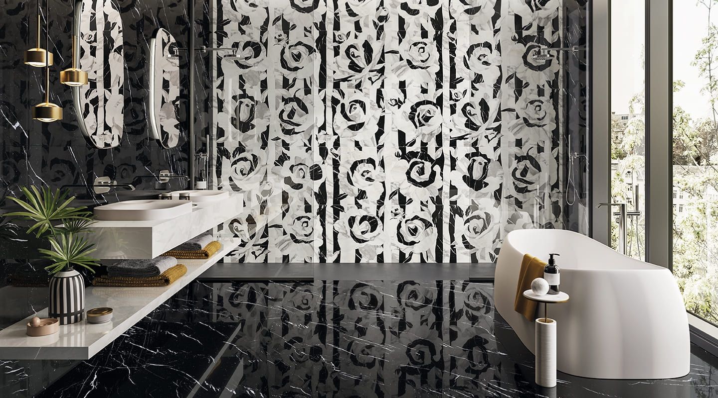 A bathroom with two sinks , a tub , a mirror and a mosaic wall.