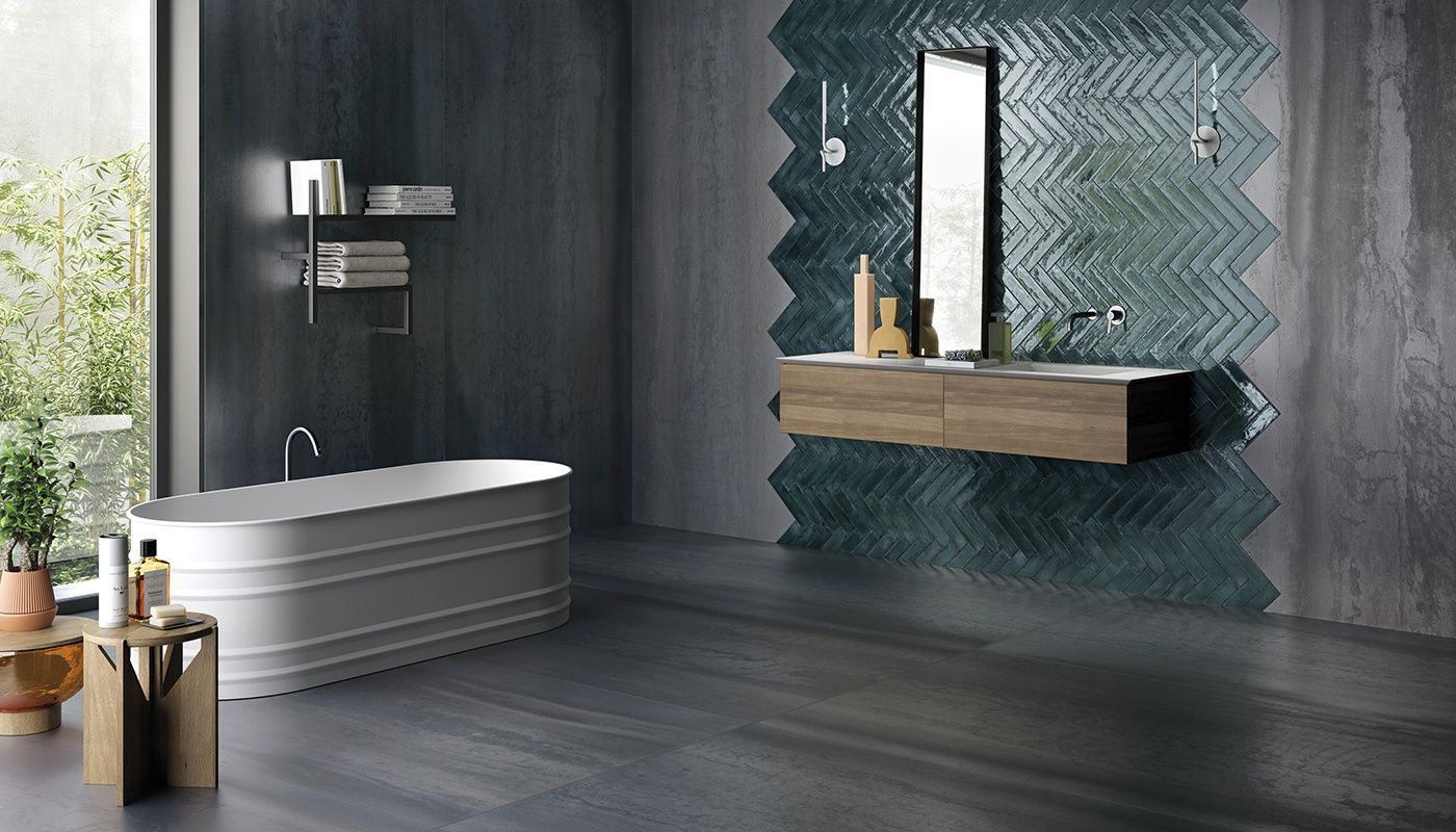 A bathroom with a bathtub , sink and mirror.