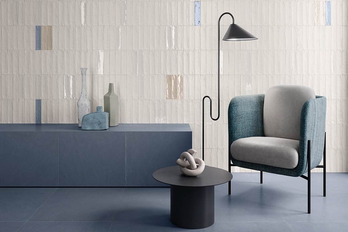 A living room with a chair , table and lamp.