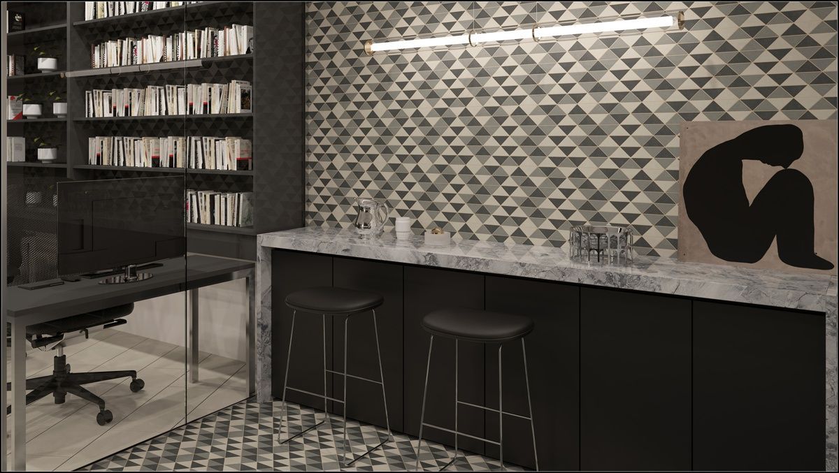 A black and white photo of a kitchen with a bar and stools.