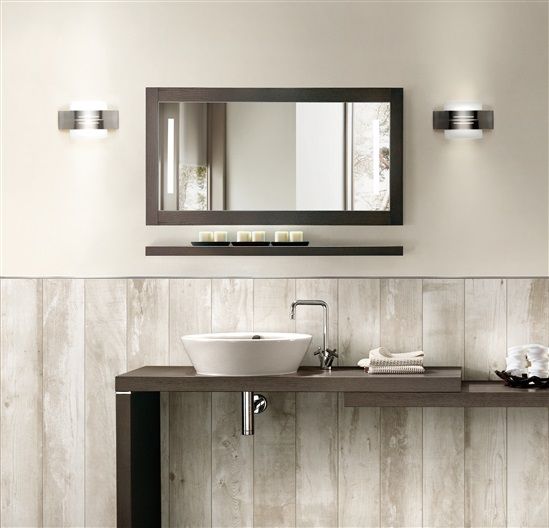 A bathroom with a sink and a mirror above it