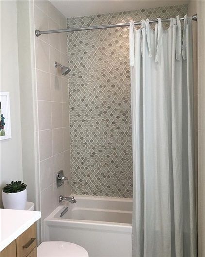 A bathroom with a bathtub and a shower curtain