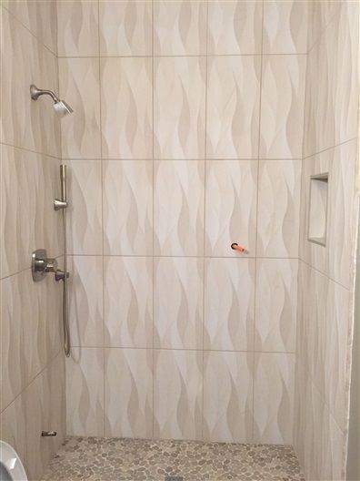 A bathroom with a walk in shower and a toilet