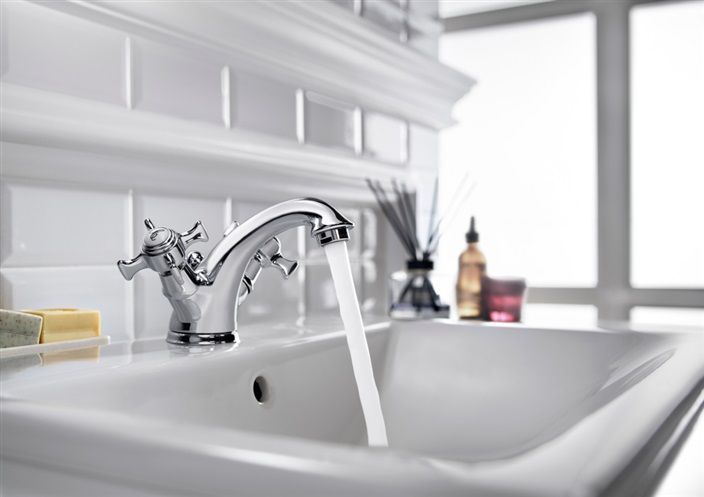 A bathroom sink with water running from the faucet