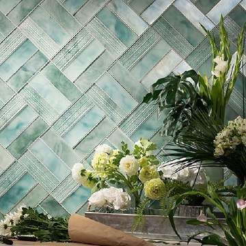 A bunch of flowers are sitting on a table in front of a wall.