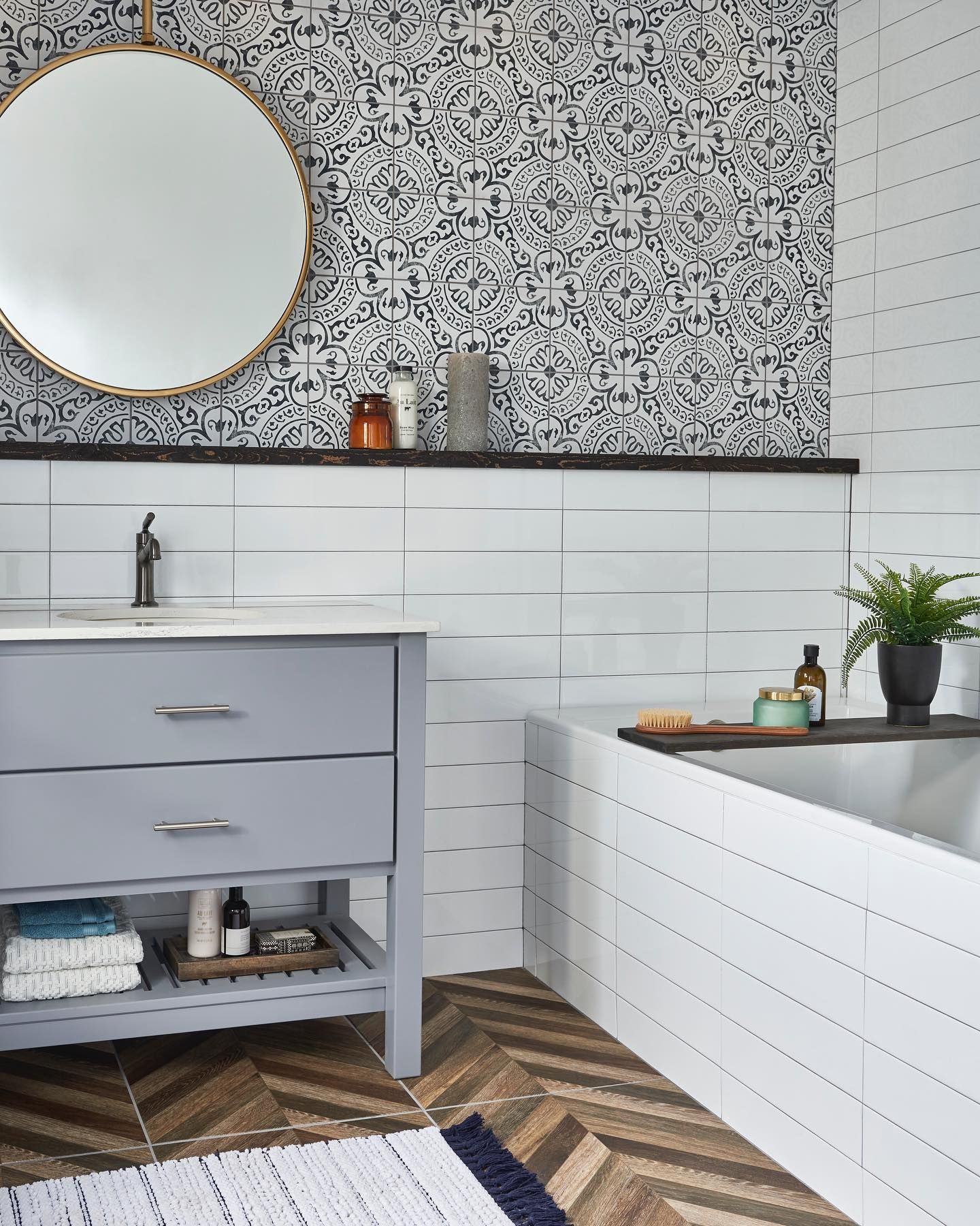 A bathroom with a sink , mirror and bathtub