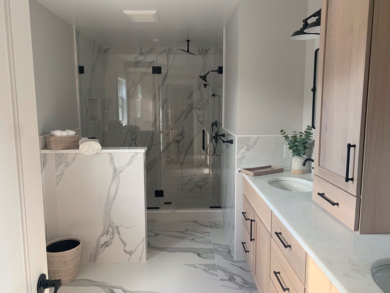 A bathroom with a sink and a walk in shower.