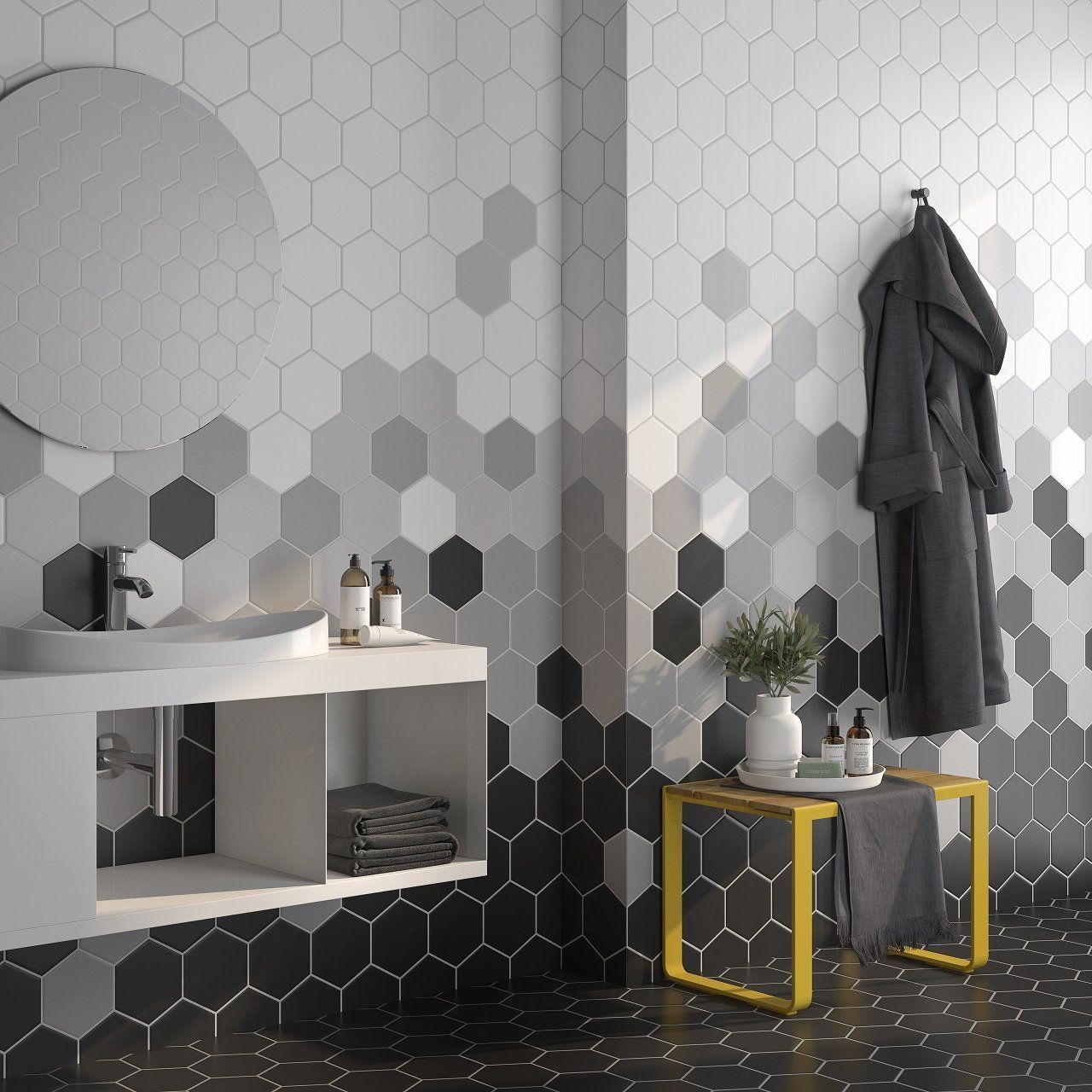 A bathroom with black and white tiles and a sink