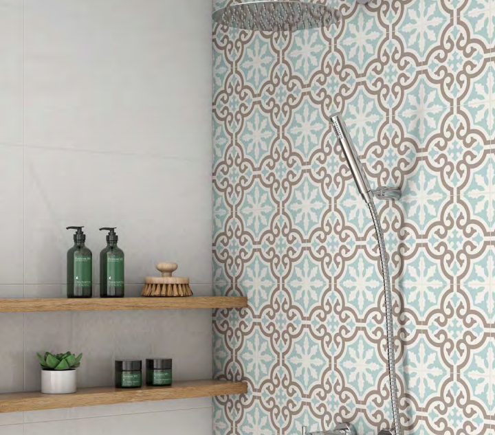 A bathroom with a shower , soap dispensers , and shelves.