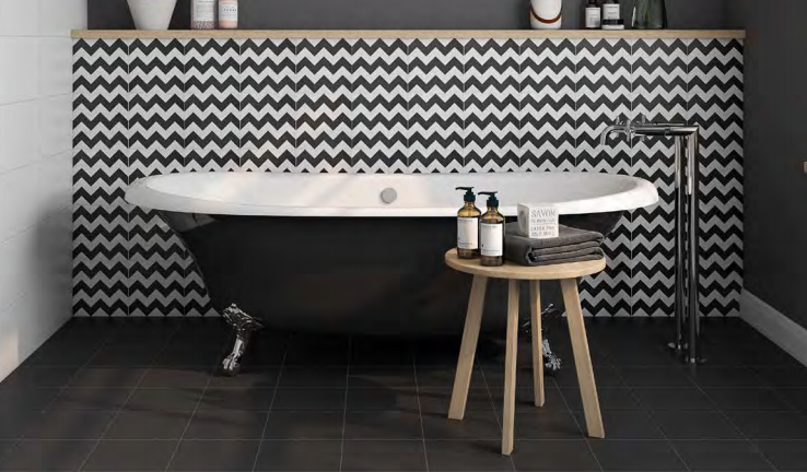 A bathroom with a bathtub and a stool in it.