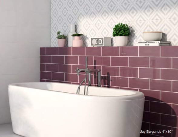 A bathtub in a bathroom with purple tiles