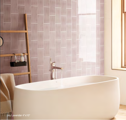 A bathtub in a bathroom with purple tiles