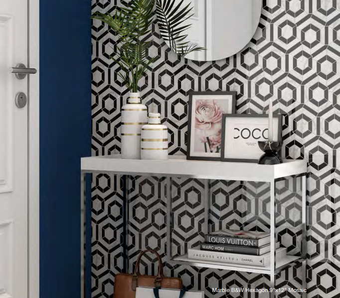 A hallway with a black and white hexagon wallpaper and a mirror.