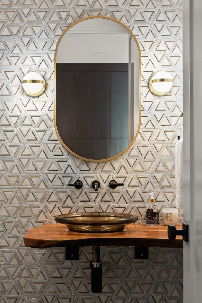 A bathroom with a sink and a mirror on the wall.