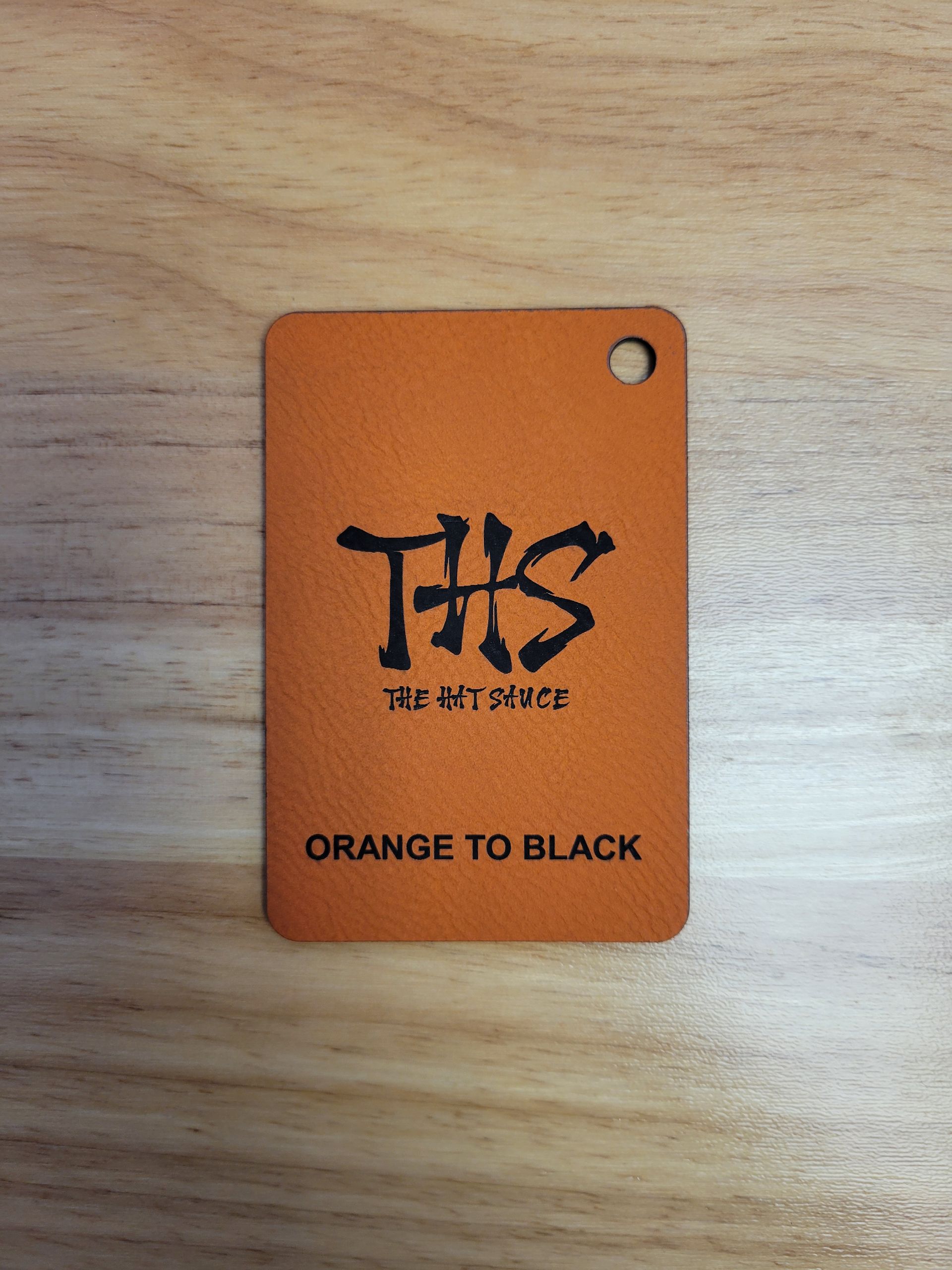 A tag that says ths orange to black on it