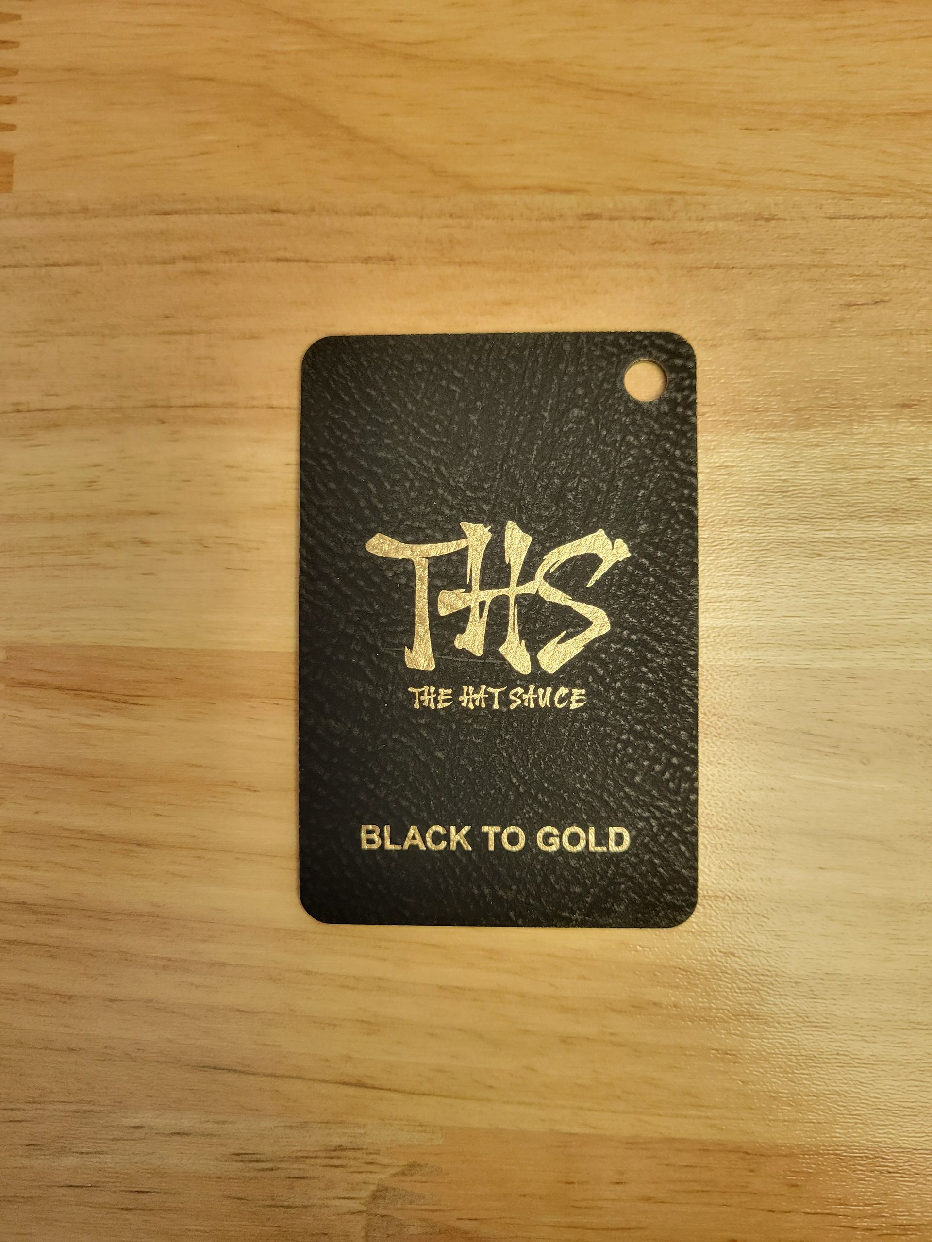 A black tag that says black to gold on it
