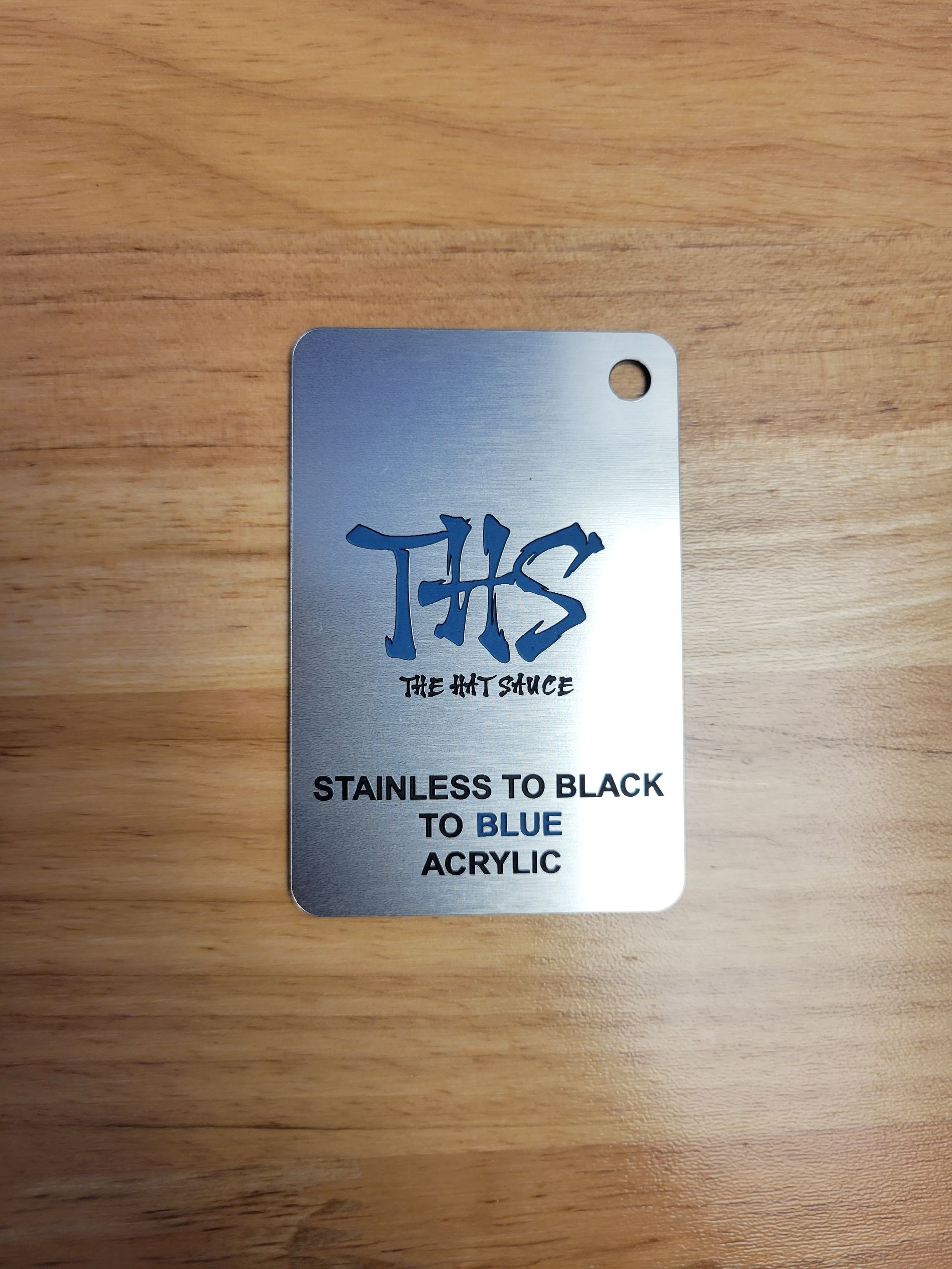 A tag that says stainless to black to blue acrylic on it