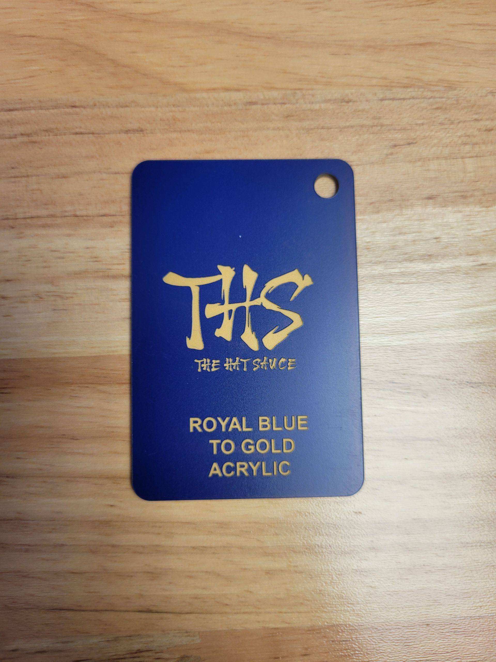 A blue tag that says ths royal blue to gold acrylic