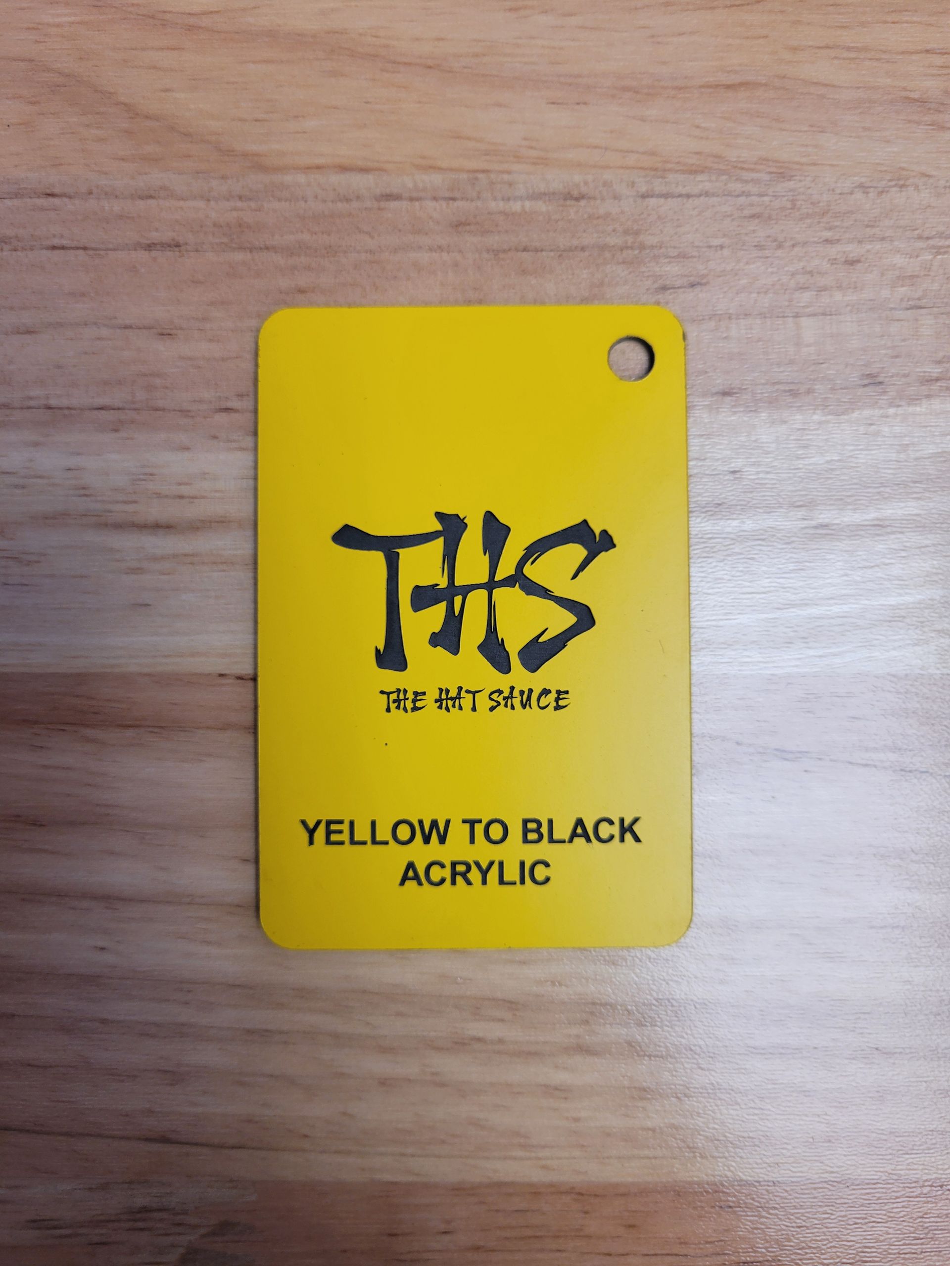 A yellow tag that says yellow to black acrylic