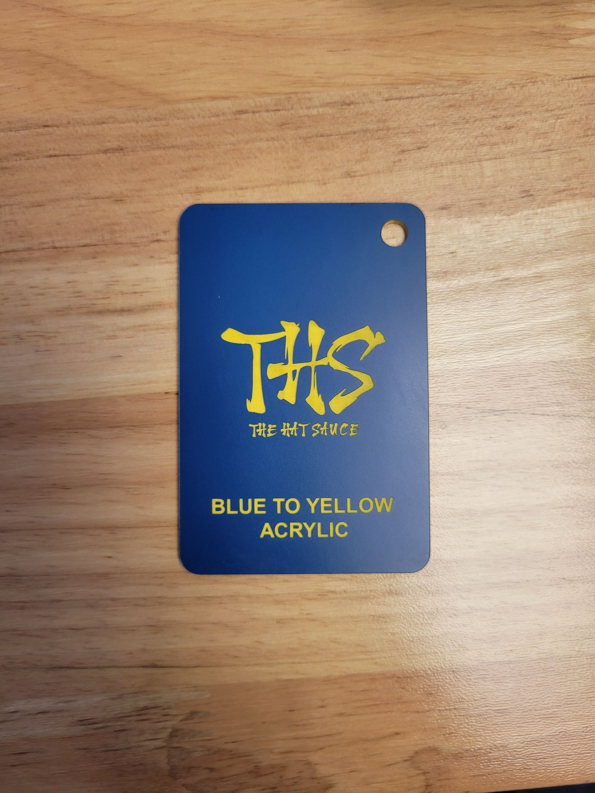 A blue and yellow tag that says ths on it