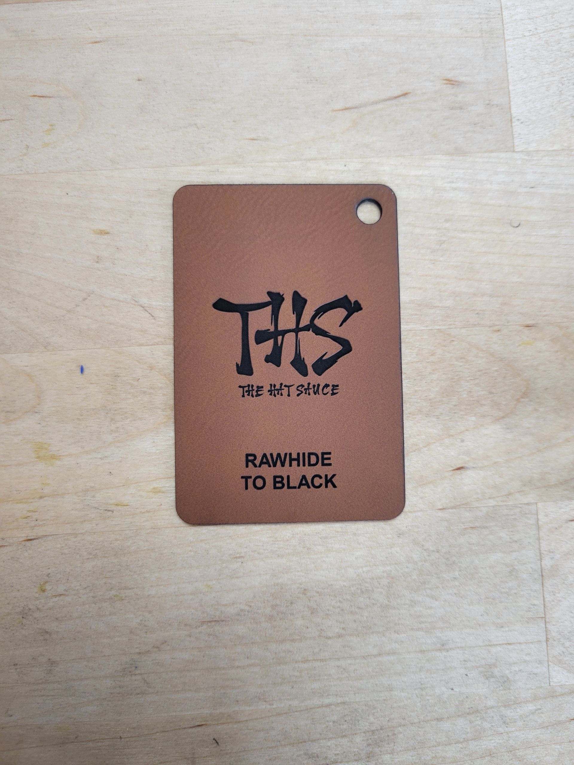 A brown tag that says rawhide to black on it