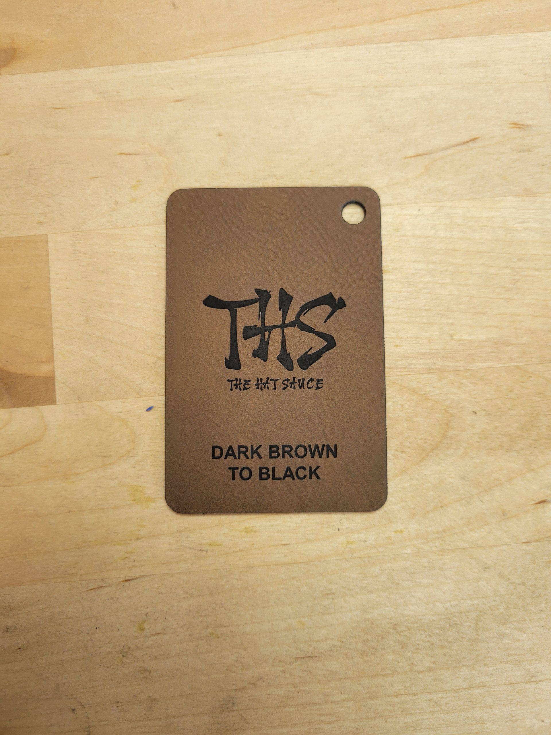 A brown tag that says this dark brown to black