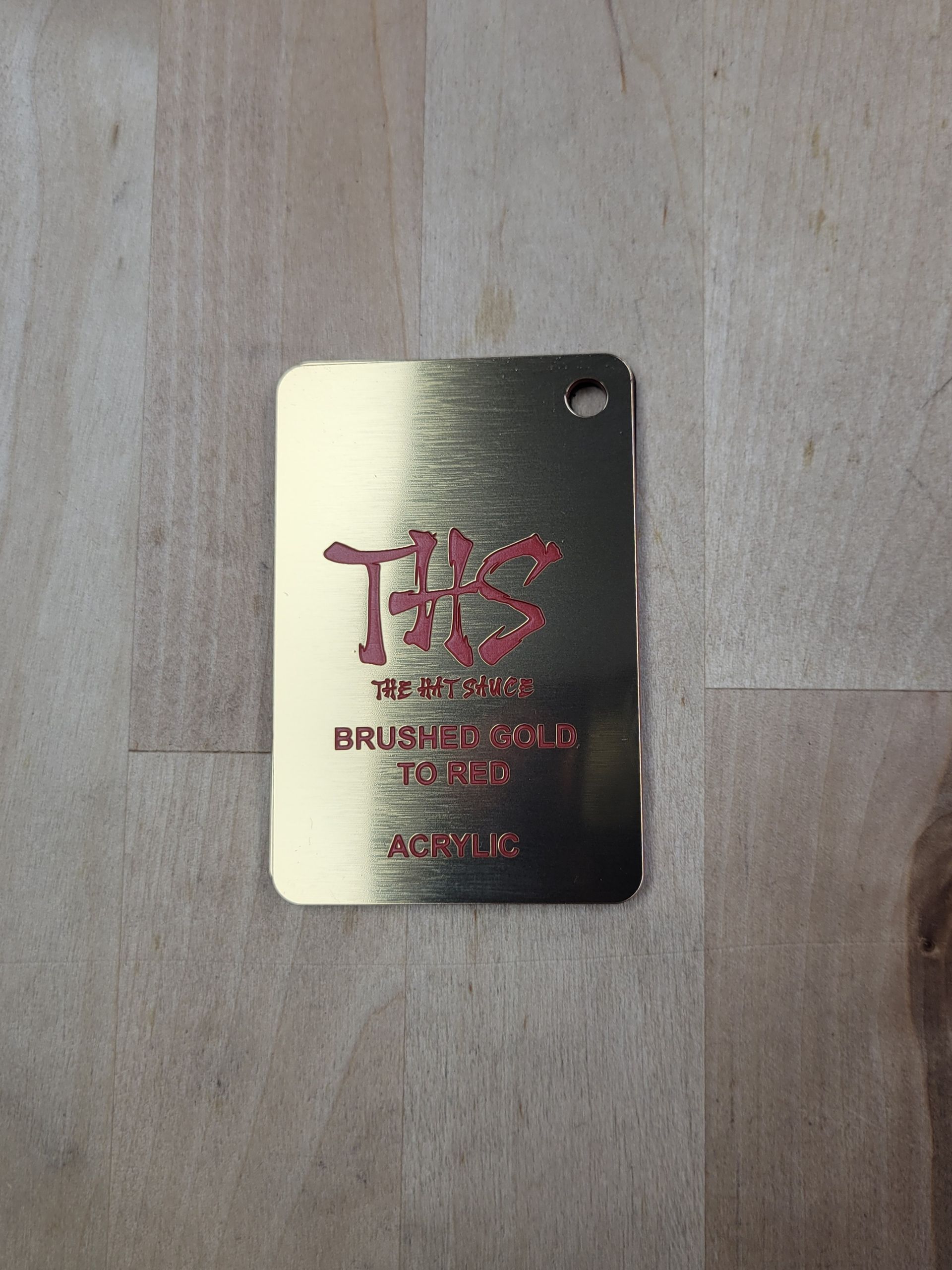 A gold tag with the letter t on it