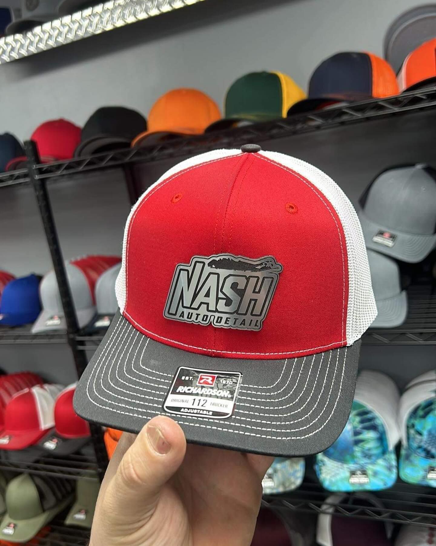 A bunch of hats are stacked on top of each other on a table in a store.