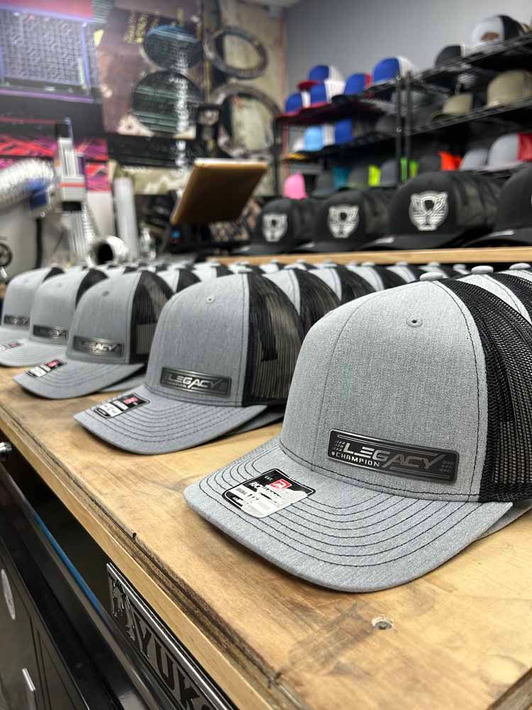 A row of hats sitting on top of a wooden shelf.