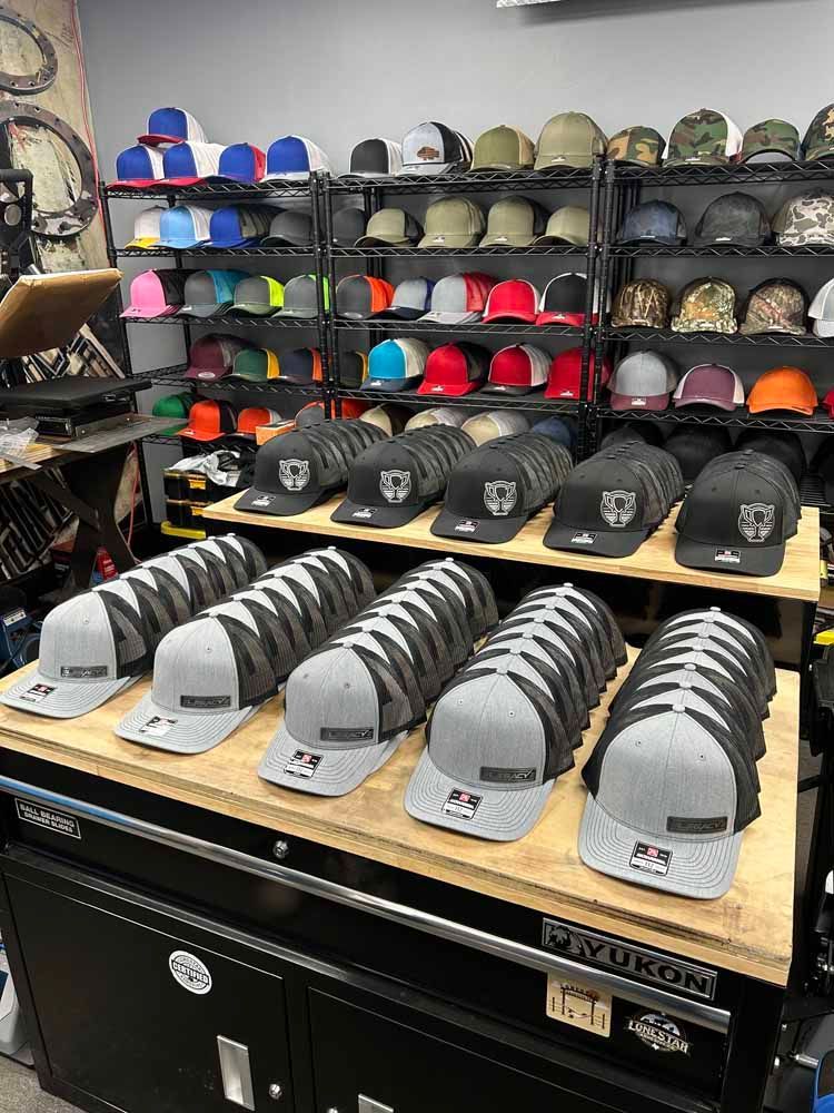 A bunch of hats are sitting on a table in a store.