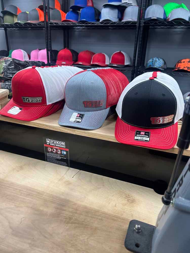 A bunch of hats are sitting on a shelf in a store.
